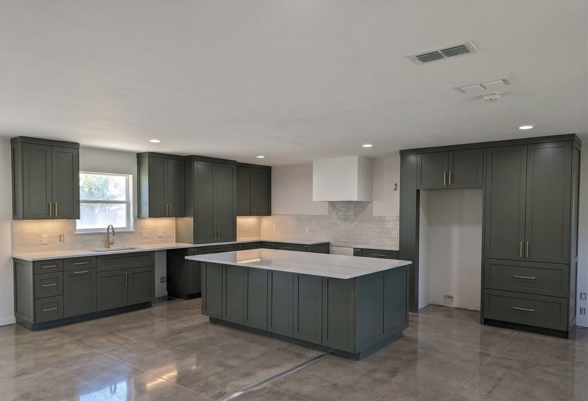 Refinished green kitchen cabinets with marble countertops in a San Antonio home