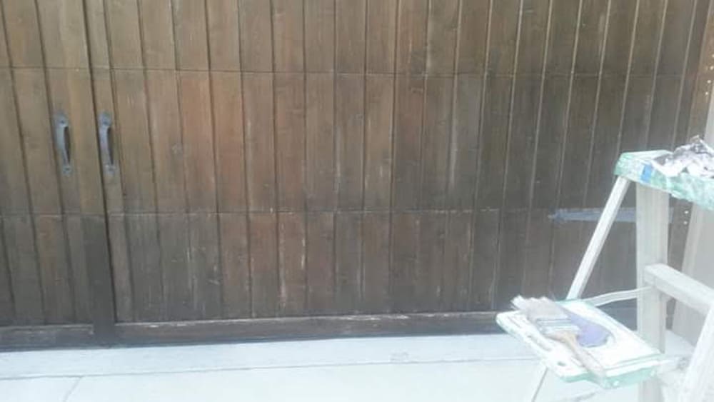 Professional crew staining wood fence